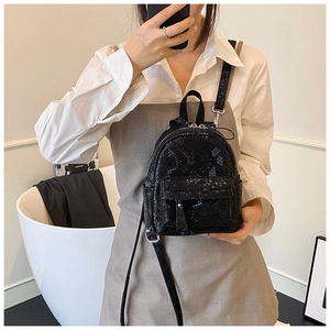Close-up of black snake pattern faux leather mini backpack with front zipper detail