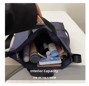 Detail showing spacious interior compartment of a navy tote bag with organized items