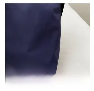Macro shot of high-quality dark blue nylon fabric texture on a large commuter tote bag