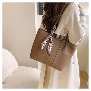 Brown lychee-texture tote bag with white stitching and silk scarf detail for work