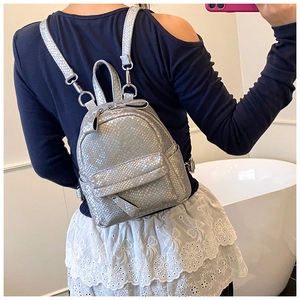 Detail shot of mini backpack with silver snake pattern texture and metallic finish zipper