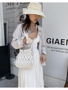 Retro cream crochet bucket bag with hollow diamond pattern and drawstring for beach vacations
