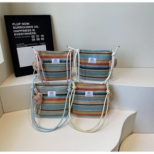 Collection of colorful knitted striped bucket bags with cute plush bear charms and long straps