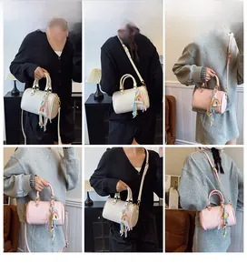 Detailed views of Boston pillow bag in cream and pink leather with decorative charms