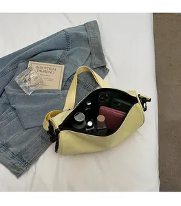 Interior view showing large capacity of the yellow pillow bag with various essentials
