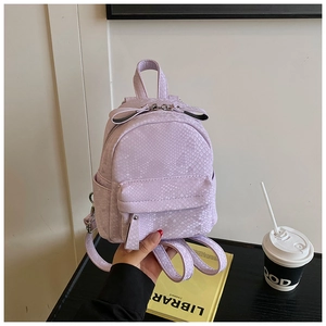 Detail of lavender faux snake skin mini backpack with bow knot and top handle