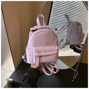 Detail view of purple snakeskin embossed mini backpack with front pocket and top handle