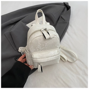 Detail of white snakeskin texture PU leather mini backpack with silver metal zippers