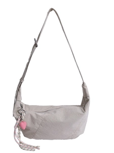 Light grey nylon crescent crossbody bag with pink heart charm and woven tassel