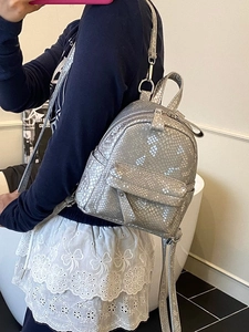 Silver snakeskin mini backpack for women featuring metallic faux leather and adjustable straps