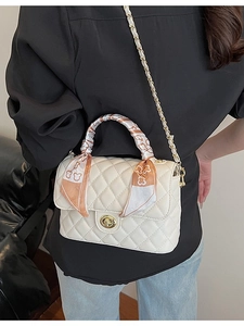 Quilted cream crossbody box bag with gold hardware and scarf-wrapped handle