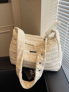 Chic quilted beige shoulder bag with wave stitching and adjustable strap for women