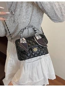 Chic black quilted crossbody bag with gold hardware and silk scarf wrapped handle
