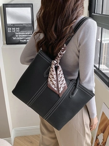 Classic black lychee leather tote bag with white contrast stitching and silk scarf