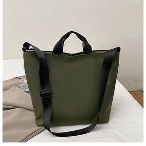 Close-up of olive green tote bag showing durable nylon texture and black shoulder strap