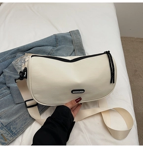 Detail of off-white crescent crossbody bag with wide strap and logo branding