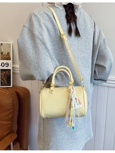 Yellow pebble leather Boston bag for women with rainbow charm and adjustable shoulder strap