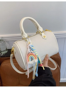White lychee pattern leather Boston handbag with gold hardware and colorful charms