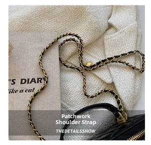 Detail of leather-interwoven chain strap and gold hardware on quilted crossbody bag