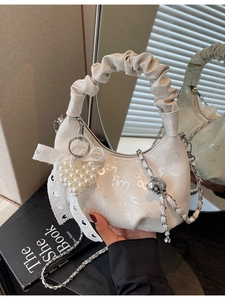 White ruched half-moon bag with embossed texture, silver chain and pearl heart charm