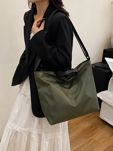 Olive green large capacity nylon tote bag shown on model for daily commuting