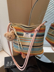 Rainbow striped woven bucket bag with pink strap and a cute bear charm for summer