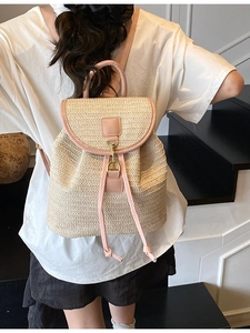 Large capacity woven straw backpack for women with pink leather trim and metal hook closure
