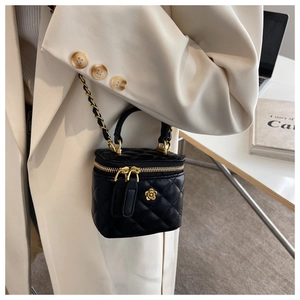 Quilted black leather mini box bag with gold camellia charm and chain strap detail
