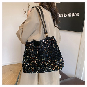 Detail of colorful sequins and golden metal ring hardware on the large tote bag shoulder strap