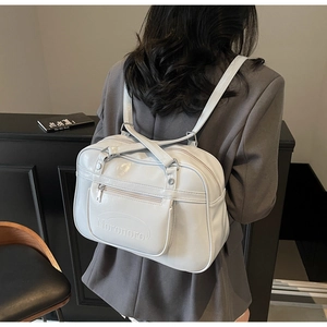 Rear view of model wearing a glossy PU backpack with Noronoro embossed branding