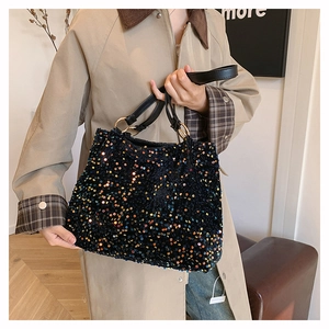 Close-up of colorful sequins on large black tote bag with gold metal ring details