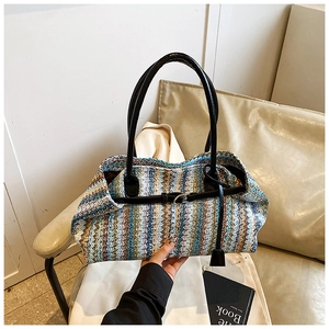 Detail of bohemian woven handbag with colorful wave patterns and leather strap accents