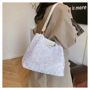 Detail of colorful sequins on white tote bag with faux leather strap and golden rings