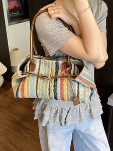 Colorful vertical striped woven straw tote bag with brown leather handles for summer beach