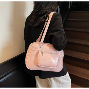 Detail of pink patent leather shoulder bag with zipper pocket on vintage stairs