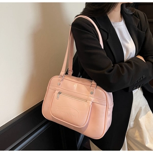 Pink faux leather shoulder bag featuring embossed lettering and silver hardware detail