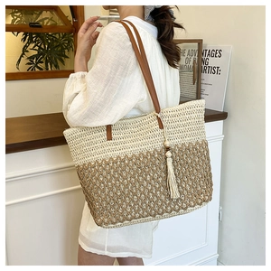 Detailed close-up of woven tote bag showing diamond knit texture and leather straps