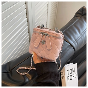 Detail der rosa gesteppten Mini-Tasche mit Kamelien-Metallanhänger und silberner Kette