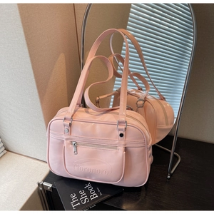 Pink PU leather tote bag with zip pocket and top handle in a lifestyle mirror reflection