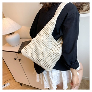 Detailed close-up of cream white crochet tote bag with openwork knit mesh pattern