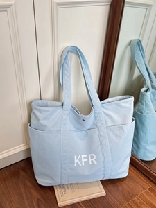 Large light blue canvas tote bag with KFR logo and dual handles for daily commuting