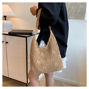 Detail of hand-woven crochet tote bag with geometric hollow patterns on shoulder strap