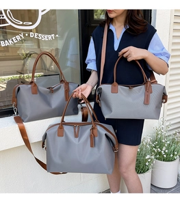 Detailed view of gray nylon tote bag with brown leather handles in outdoor lifestyle setting