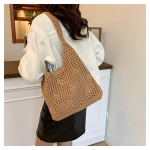 Detail of the brown hand-woven crochet mesh tote bag texture and reinforced bottom base