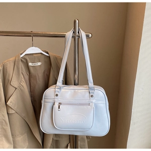 Detail of light blue Noronoro shoulder bag featuring silver zippers on a metal hanger