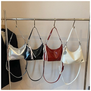 Detailed display of crescent bags in silver, black, red, and cream glossy oil wax leather