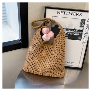 Detail of hand-woven crochet shoulder bag featuring intricate hollow knit and wide straps