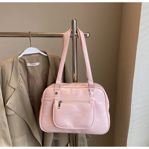 Detailed view of pink patent leather backpack with Noronoro embossed lettering decoration