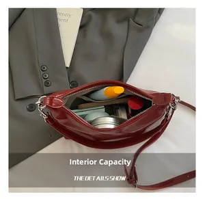 Internal capacity of the red glossy tote bag showing storage for cosmetics and essentials