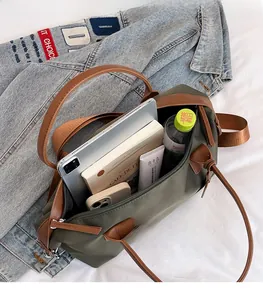 Spacious interior of army green tote bag showing organization for tablet and daily items